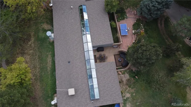 an aerial view of residential house with outdoor space and trees