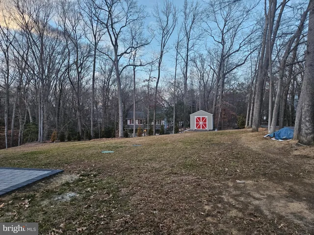 a sign board in front of a white house
