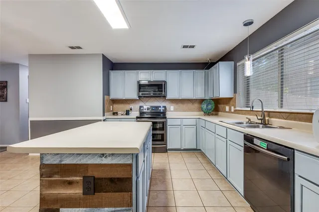 a kitchen with a sink stove and microwave