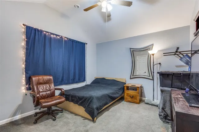 a bedroom with a bed a couch and a chandelier