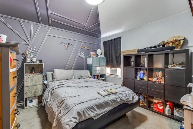 a bedroom with a bed closet and a chandelier