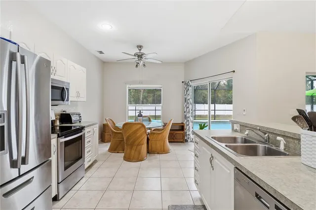 a kitchen that has a sink cabinets counter space appliances and a window