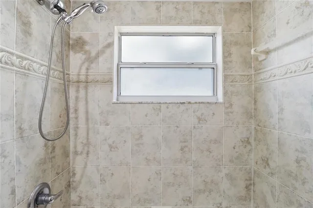 a bathroom with a glass shower door
