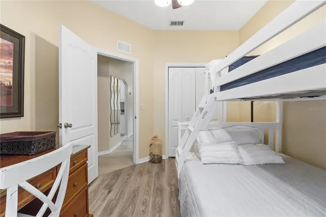 a spacious bedroom with a large bed and a walk in closet