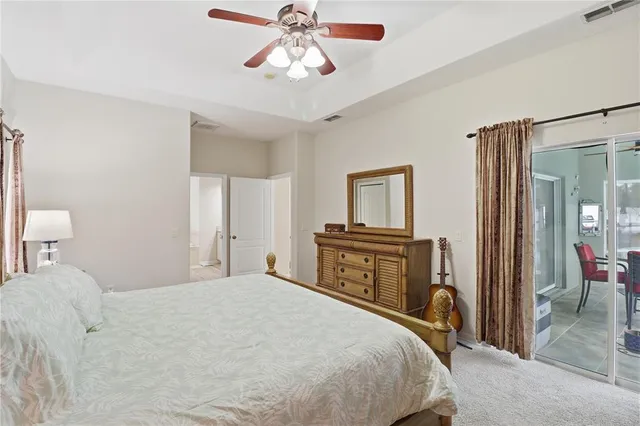 a bedroom with a bed dresser and a flat tv screen