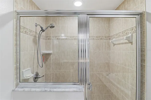 a bathroom with a glass shower door