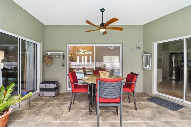 a dining room with a glass table and chairs