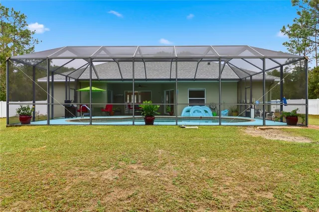 a view of a patio with a table and chairs under an umbrella