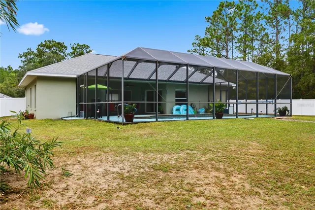 a view of a house with a backyard and a patio