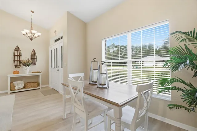 a view of a dining room with furniture and window