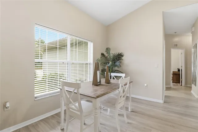 a dining room with furniture and window