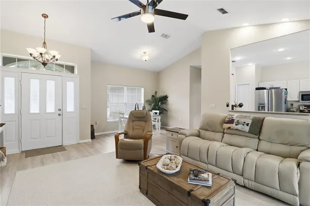 a living room with furniture and a chandelier