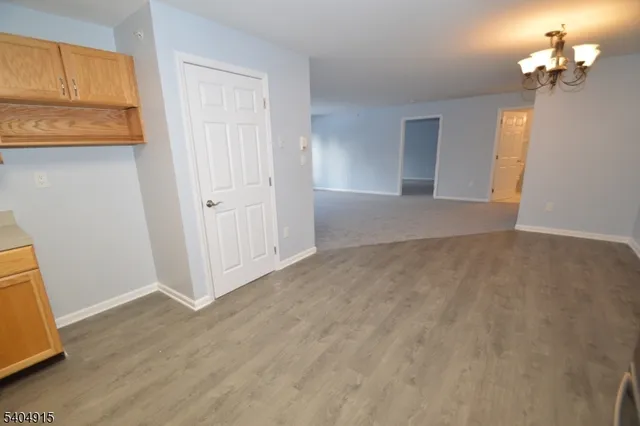 a view of a kitchen with wooden floor and a cabinet