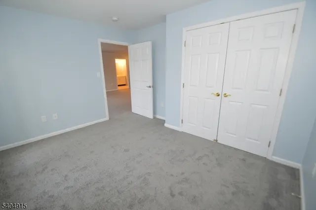 an empty room with closet area