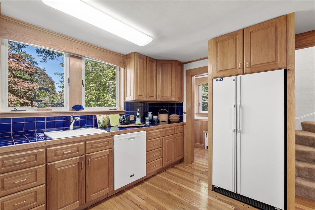 58 Country Club Road Newton, MA 02459 - Photo 9 of 27 a kitchen with stainless steel appliances a refrigerator sink and cabinets
