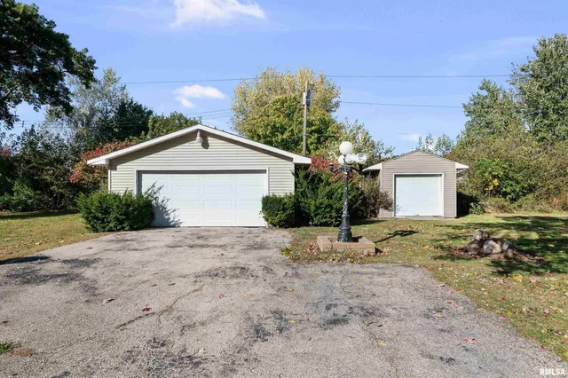 a view of a house with a yard and garage