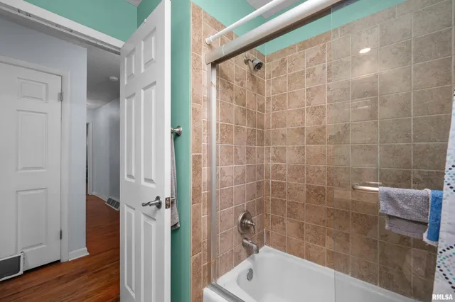 a bathroom with a bathtub and a shower