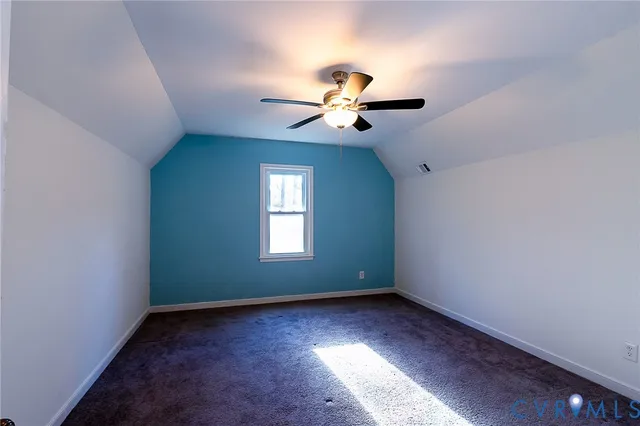 a view of room with a ceiling fan and window