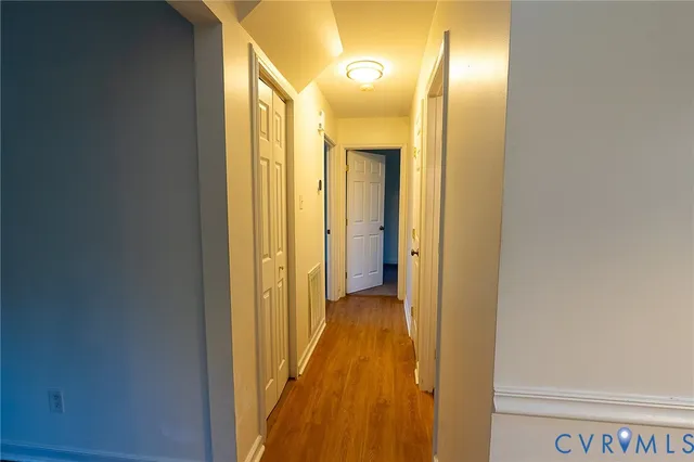 a view of a hallway with wooden floor