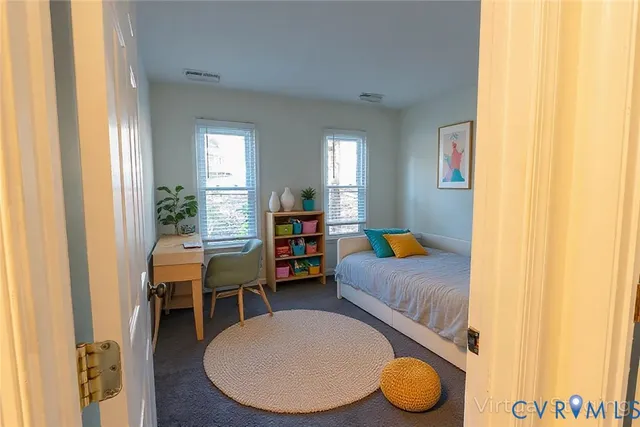 a bedroom with furniture and a chair