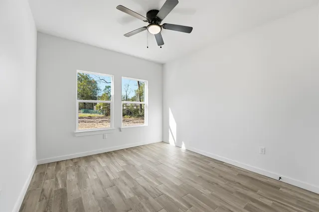 wooden floor in an empty room with a window