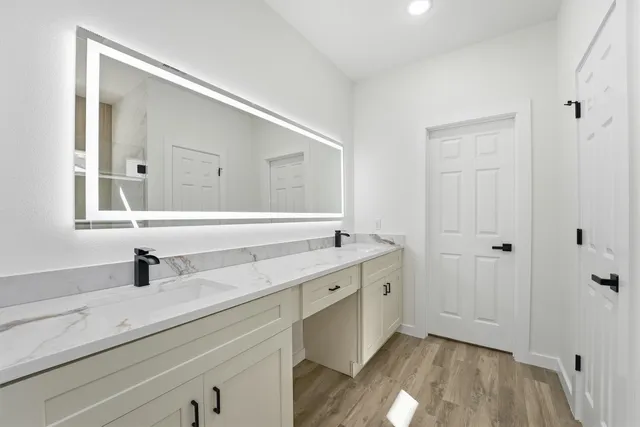 a bathroom with a sink and a mirror