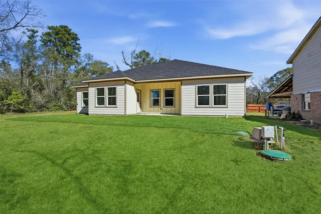 a house view with a sitting space and garden
