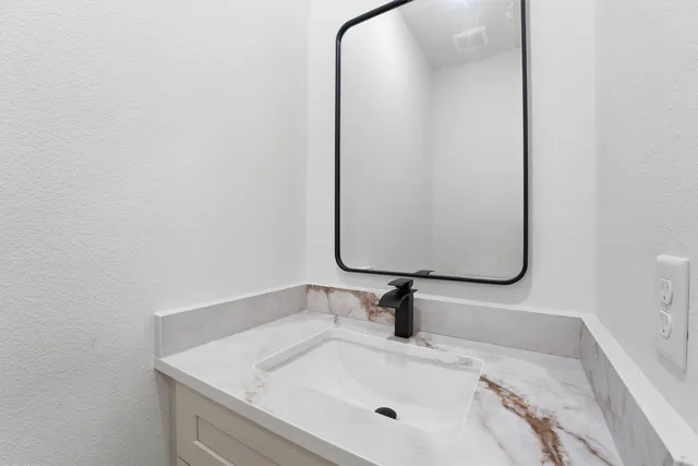 a bathroom with a sink and mirror