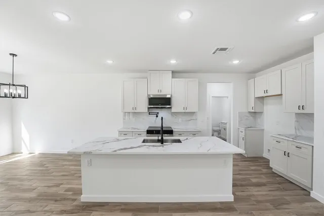 a kitchen with stainless steel appliances a sink stove and refrigerator