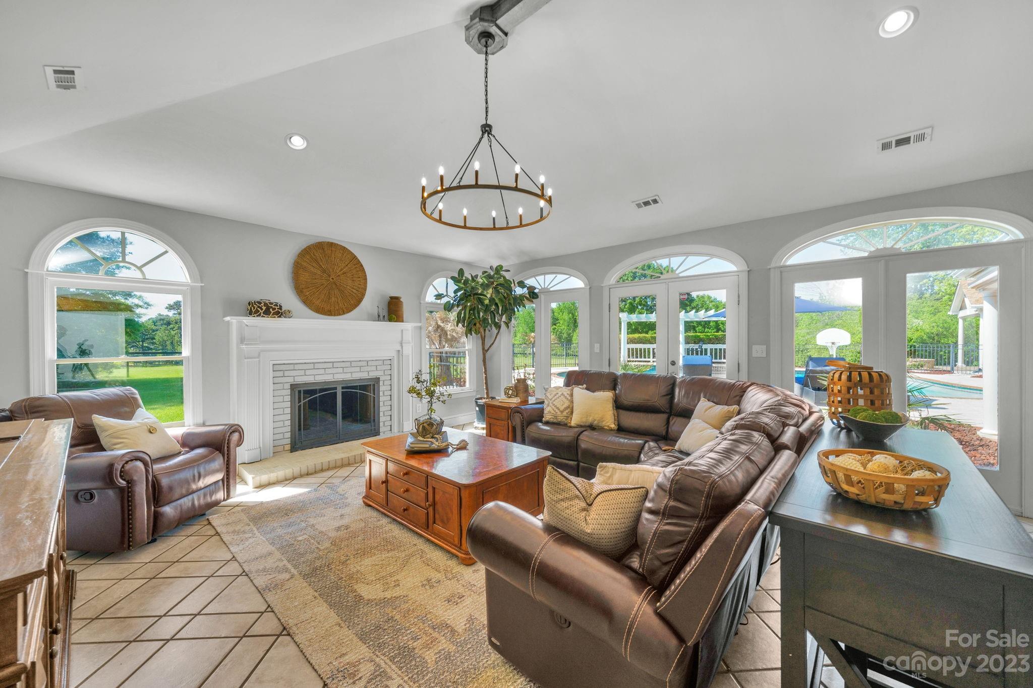 1916 Cox Road Matthews, NC 28104 - Photo 20 of 47 a living room with furniture a fireplace and a large window