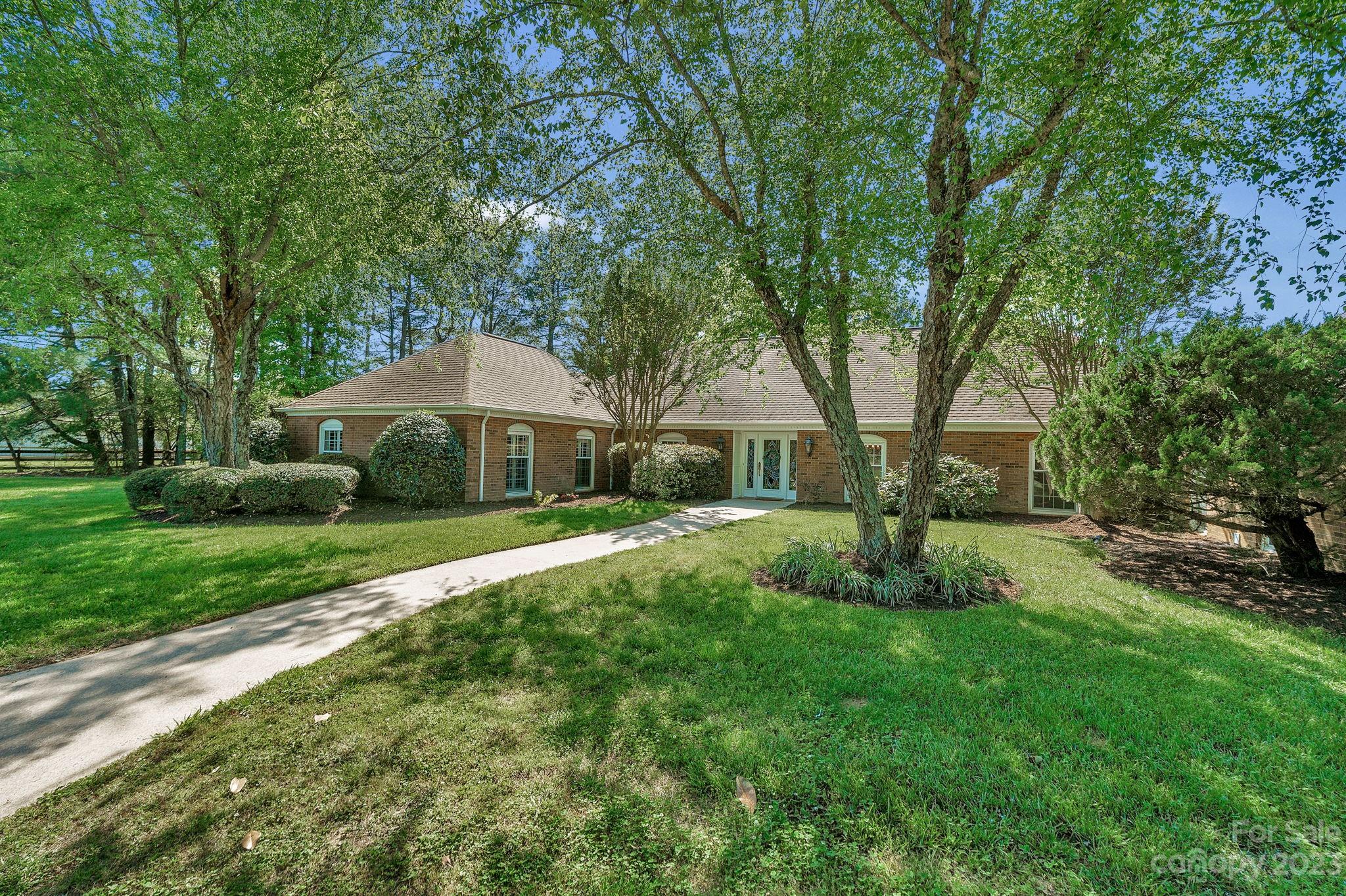 1916 Cox Road Matthews, NC 28104 - Photo 2 of 47 a front view of a house with a yard
