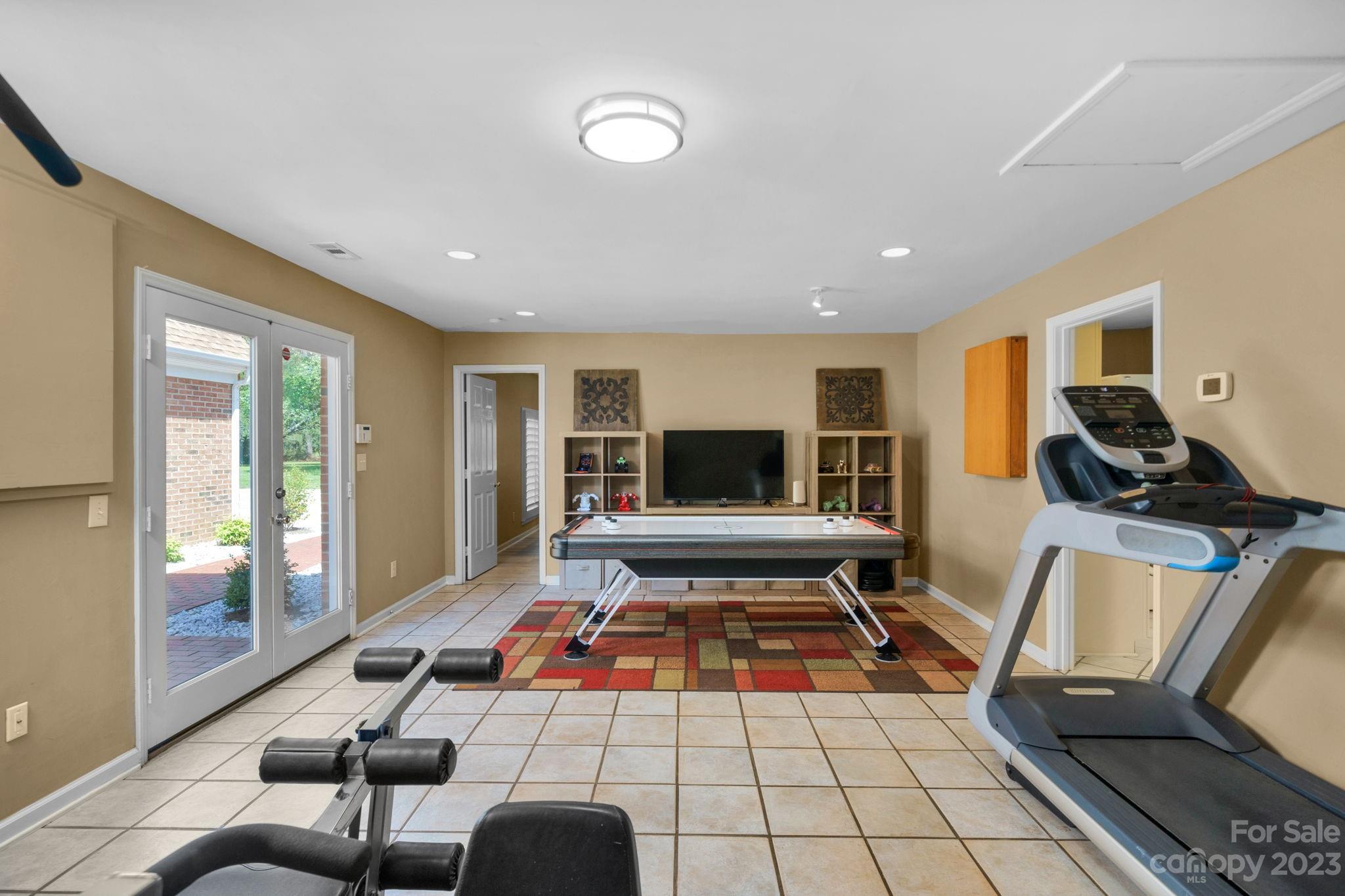 1916 Cox Road Matthews, NC 28104 - Photo 30 of 47 a living room with furniture a flat screen tv and a floor to ceiling window