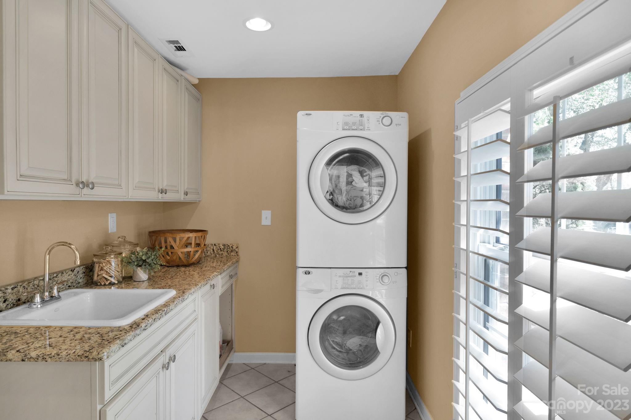 1916 Cox Road Matthews, NC 28104 - Photo 31 of 47 a kitchen with a sink a washer and dryer