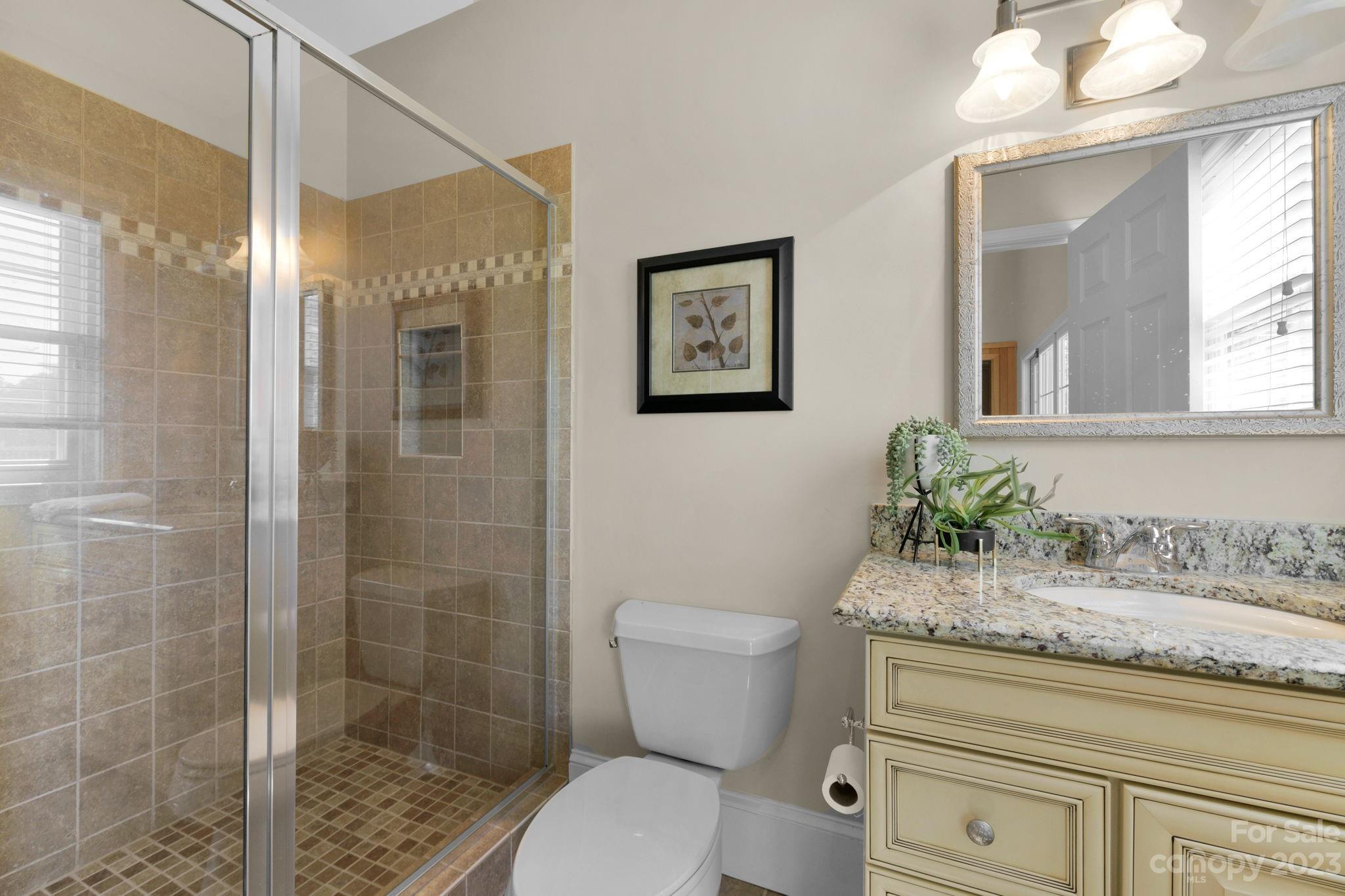 1916 Cox Road Matthews, NC 28104 - Photo 34 of 47 a bathroom with a granite countertop toilet sink and shower