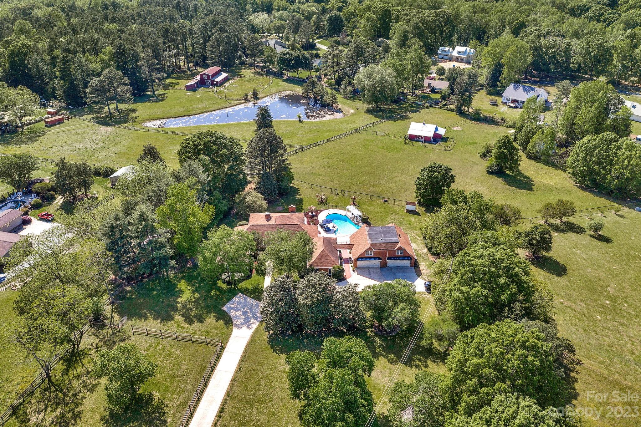 1916 Cox Road Matthews, NC 28104 - Photo 7 of 47 an aerial view of a house with a yard and lake view