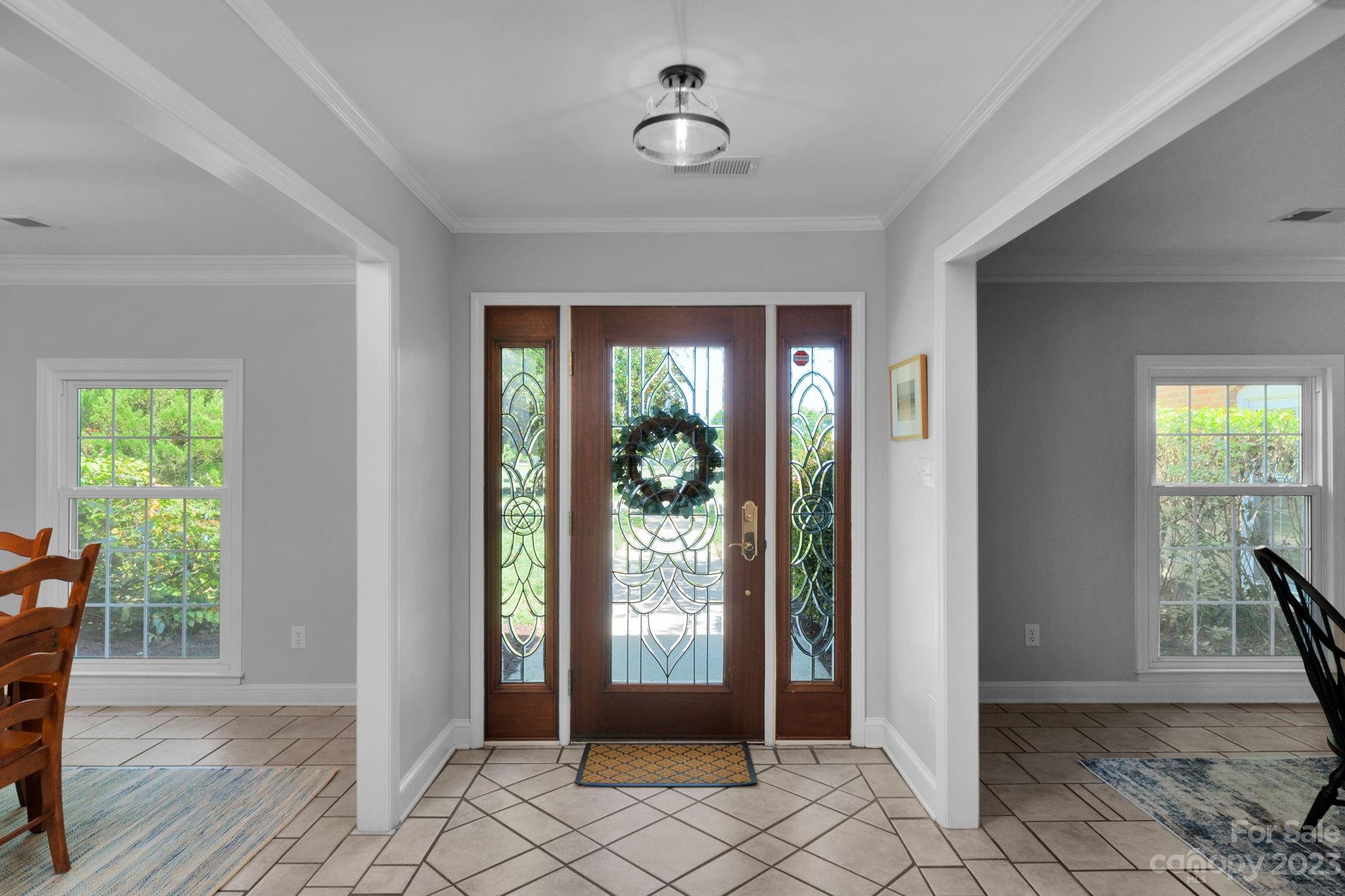 1916 Cox Road Matthews, NC 28104 - Photo 9 of 47 a view of an entryway with wooden floor and a livingroom