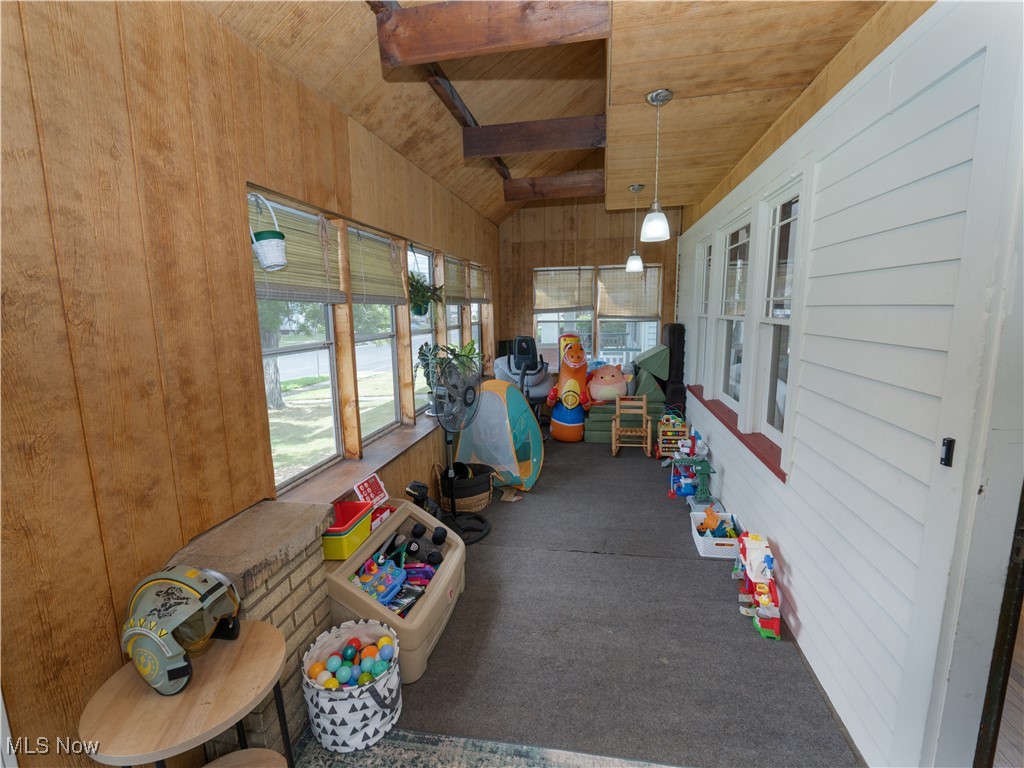 6021 Snow Road Parma, OH 44129 - Photo 2 of 28 Sunroom / Enclosed front porch with wooden walls, carpet floors, and wooden ceiling