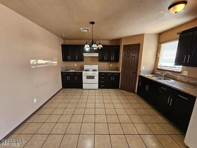 a kitchen with a sink and a refrigerator