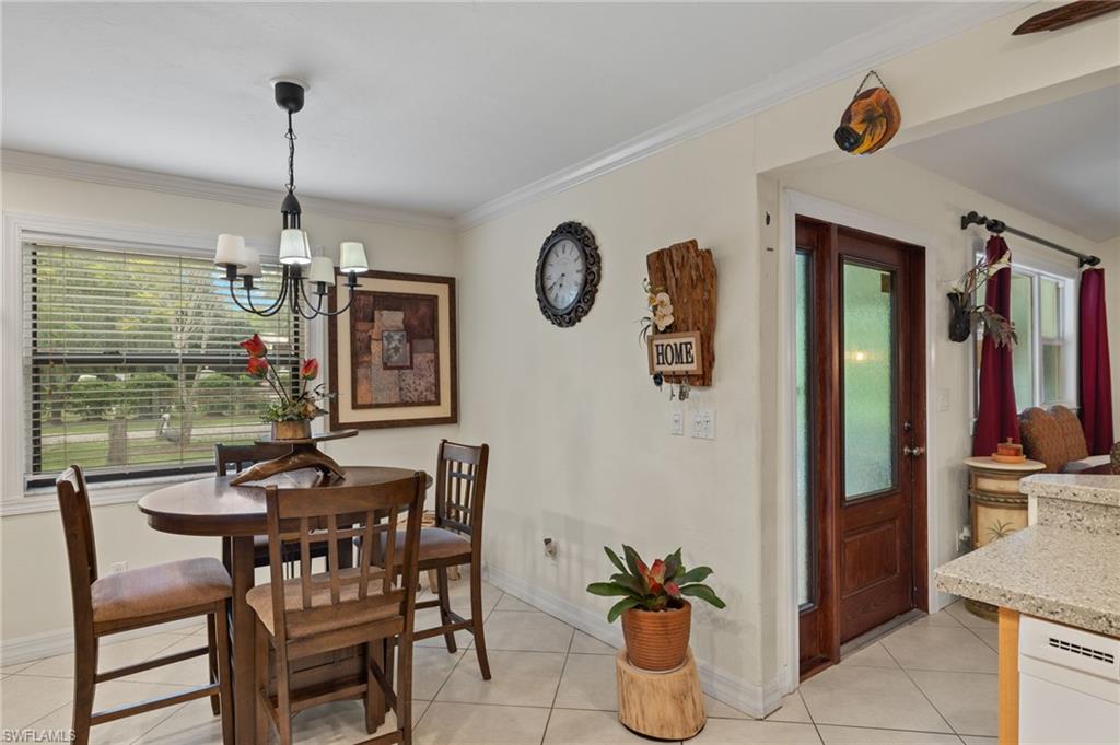 5730 Cedar Tree Lane Naples, FL 34116 - Photo 12 of 22 a dining room filled with furniture and window