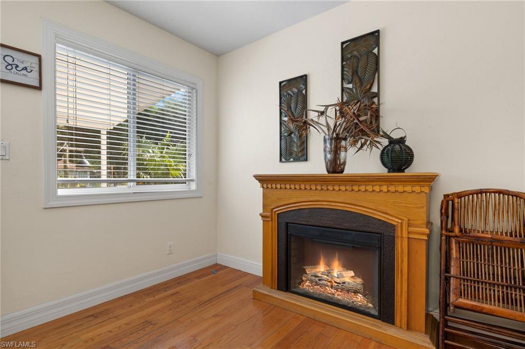 5730 Cedar Tree Lane Naples, FL 34116 - Photo 15 of 22 a view of a livingroom with a fireplace and window