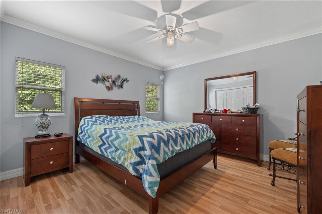 5730 Cedar Tree Lane Naples, FL 34116 - Photo 16 of 22 a bedroom with a bed and a window
