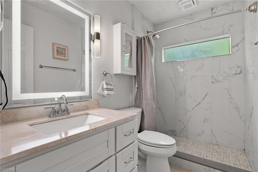 5730 Cedar Tree Lane Naples, FL 34116 - Photo 18 of 22 a bathroom with a sink toilet and shower