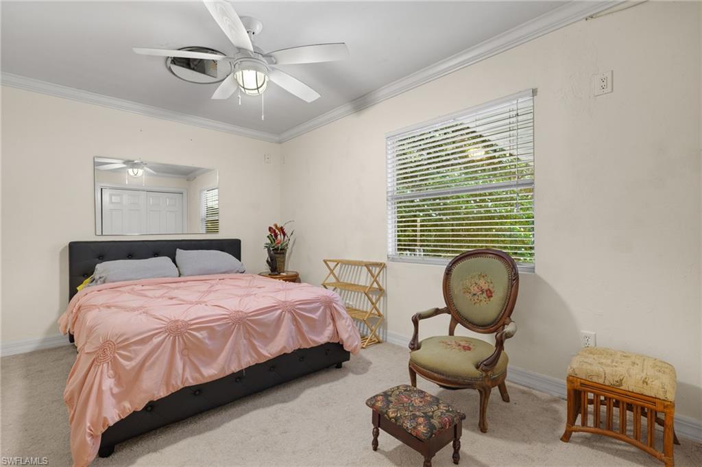 5730 Cedar Tree Lane Naples, FL 34116 - Photo 19 of 22 a bedroom with bed and a chandelier