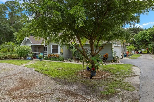 a view of a house with a yard and tree s
