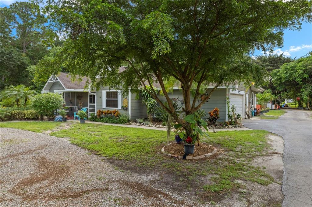 5730 Cedar Tree Lane Naples, FL 34116 - Photo 2 of 22 a view of a house with a yard and tree s