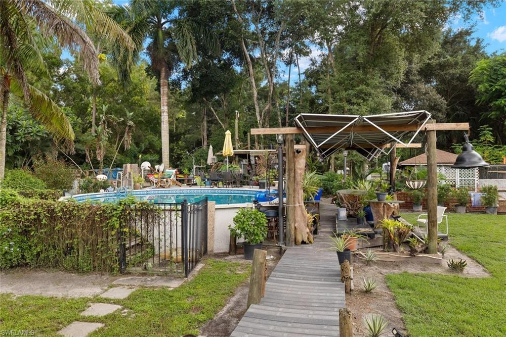 5730 Cedar Tree Lane Naples, FL 34116 - Photo 21 of 22 a view of a chair and tables in the patio
