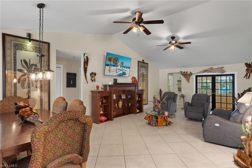 5730 Cedar Tree Lane Naples, FL 34116 - Photo 3 of 22 a living room with furniture and a chandelier