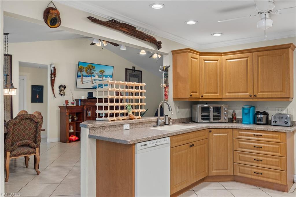 5730 Cedar Tree Lane Naples, FL 34116 - Photo 9 of 22 a kitchen with stainless steel appliances granite countertop a sink and cabinets