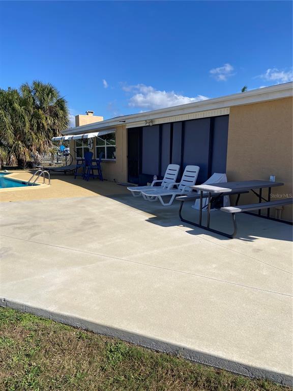 5343 Bluepoint Drive Port Richey, FL 34668 - Photo 11 of 28 a swimming pool with outdoor seating and yard