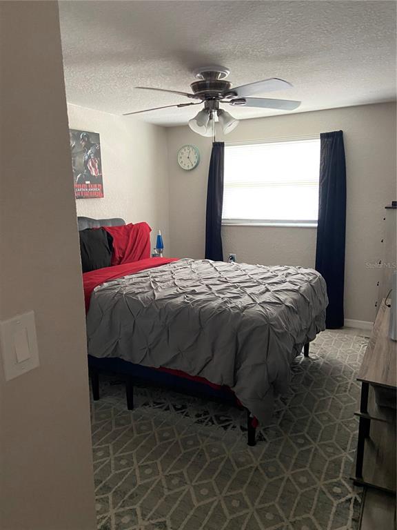 5343 Bluepoint Drive Port Richey, FL 34668 - Photo 15 of 28 a bedroom with a bed and a chandelier